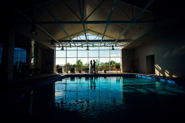 just married kissing at pool