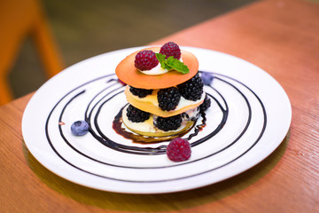 Cake with berries on white plate