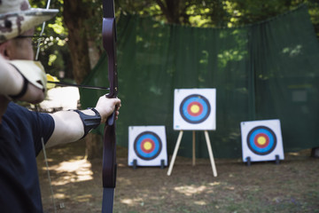 Training exercises for shooting archery on an outdoor target.