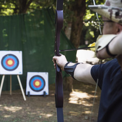Training exercises for shooting archery on an outdoor target.