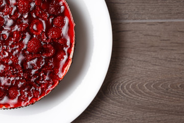 Raspberry jelly cake. The view from the top, flat at the top. Copy space and text. On a wooden table