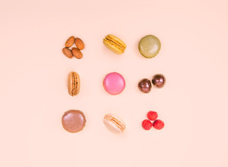 Colorful macaroons on the pink background.