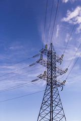 Electricity Pylon
lone power transmission line tower on blue sky background