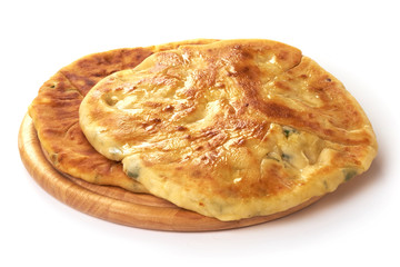 Georgian khachapuri with cheese and green herbs inside, isolated on white background.