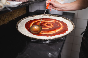 Close up shot of pizza making or preparing process