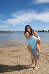 Young happy couple on seashore beach summer