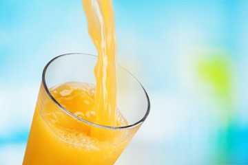 Orange juice glass on blur background