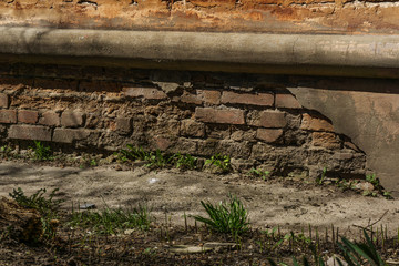 collapsing basement of an old brick building with falling plaster