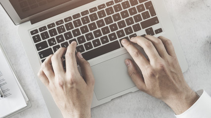 Male hands using laptop computer