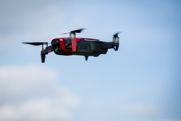 Fototapeta na wymiar A drone hovering in a blue sky