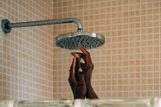 Woman hands taking a shower