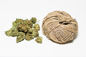 Marijuana buds up close with ball of hemp string.