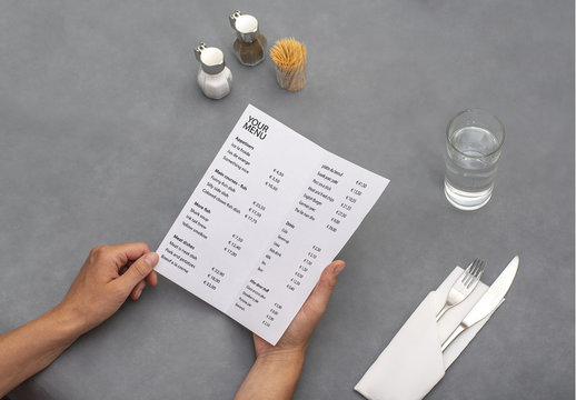 Hands Holding Menu At Diner Table Mockup