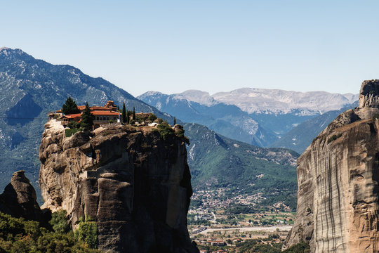 Monastery Holy Trinity in Meteora mountains, Thessaly, Greece. Panoramic view of Meteora monastery on the high rock at summer time
