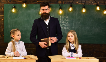 High school college students studying and reading together in class education concepts. Education at the elementary school - pupil writing in notepad at his desk happy