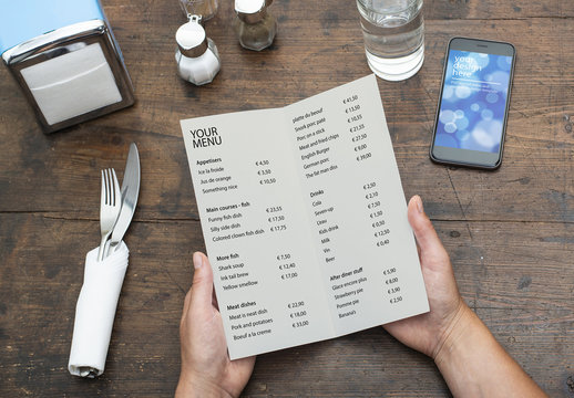 Restaurant Menu and Smartphone on Wooden Table Mockup