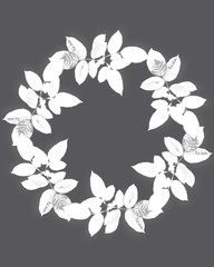 Round wreath of twigs with white leaves on a dark background