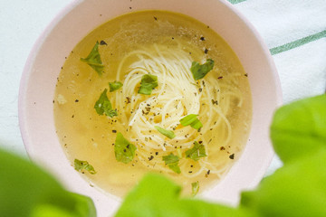 Homemade chicken soup with herbs
