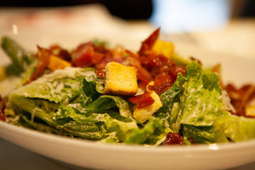 Delicious Caesar Salad made with crispy Romaine lettuce, homemade croutons, parmesan cheese, and easy homemade dressing with lots of bacon.