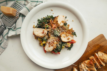 Chicken salad with vegetables on white plate