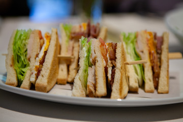 Close up of Club sandwiches by its side. Can see all delicious filling.