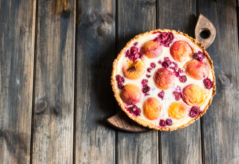 Rustic open pie with peach and raspberry, french galette . Peach tart. Raspberry tart. Tartalette with cream. Variety of bakery.