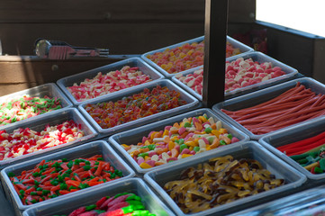 Assorted colorful jelly candies on display at a street market.
