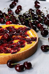 cherry cake and a bunch of cherries on table