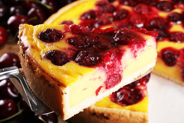 cherry cake and a bunch of cherries on table.