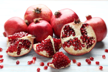 Ripe and juicy pomegranate on wooden table