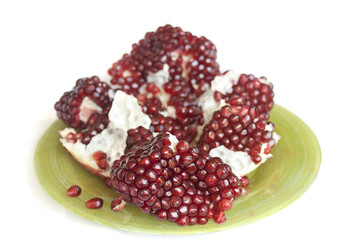 pomegranate on a plate isolated on white