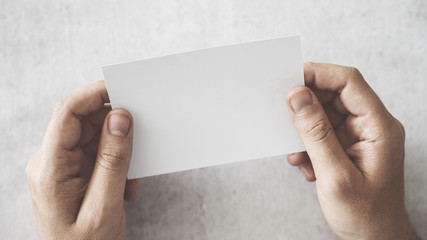 Hand holding a business card