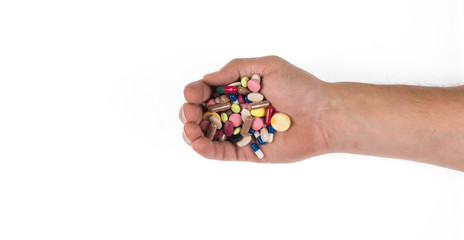 hand with medicinal pills on a white background