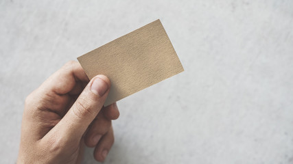 Hand holding a blank business card
