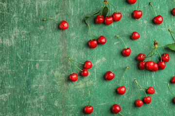 Flat lay composition with sweet red cherries on wooden background