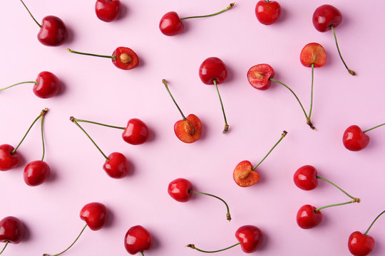 Ripe red cherries on color background, top view