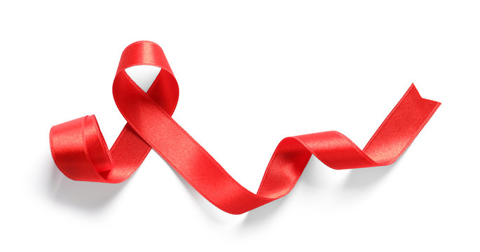 Red ribbon on white background, top view. Cancer awareness