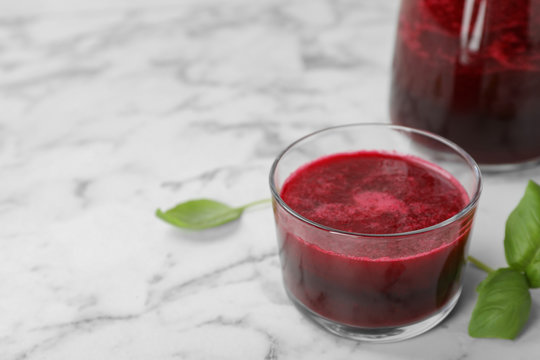Glass of fresh natural beet juice on table