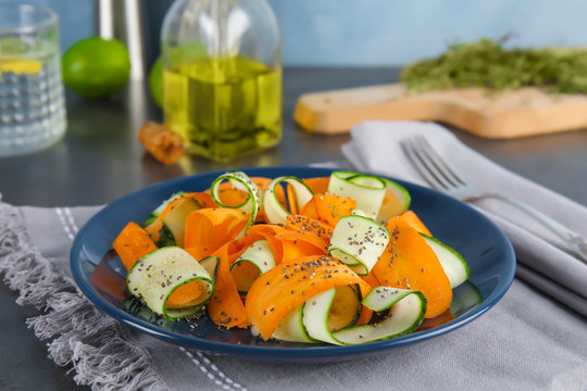 Plate with tasty carrot salad on table