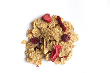 Corn flakes with dried srawberries and cherrys isolated on white