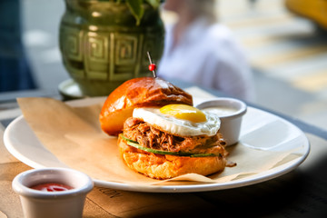 Burger with beef stew and egg lying on a plate