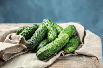 Ripe fresh cucumbers on wooden table