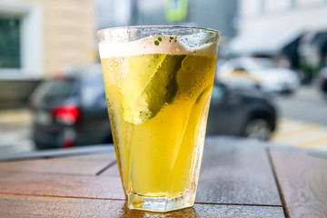 Iced tea in a misted glass is on the table.