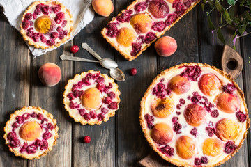 Rustic open pie with peach and raspberry, french galette . Peach tart. Raspberry tart. Tartalette with cream. Variety of bakery.