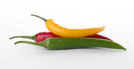 Ripe hot chili peppers on white background