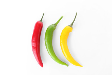 Ripe hot chili peppers on white background