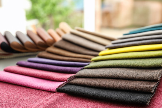 Fabric samples of different colors for interior design on table