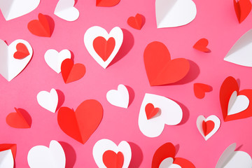 Small paper hearts on color background, top view