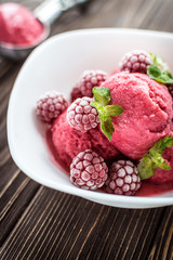 Delicious ice cream  made from fresh berries on a wooden background