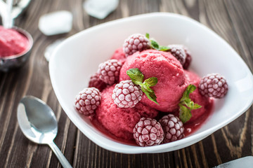 Delicious ice cream  made from fresh berries on a wooden background